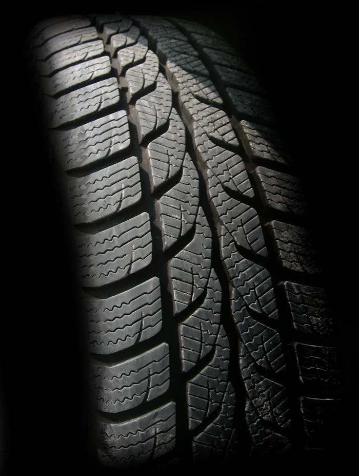 Detailed close-up image of a rubber tire showcasing texture and tread pattern, ideal for design concepts.